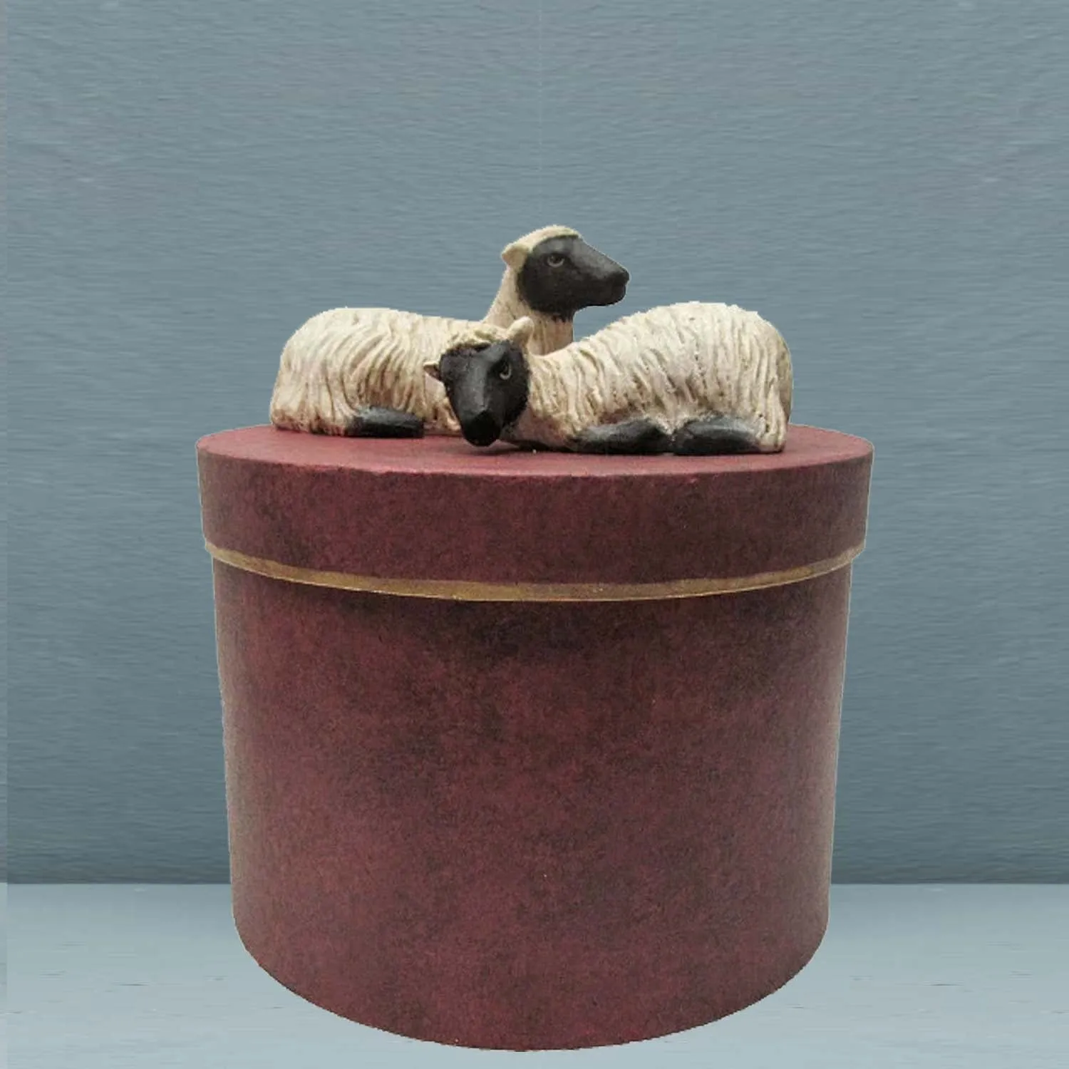 PAIR OF SHEEP ON ROUND BOX