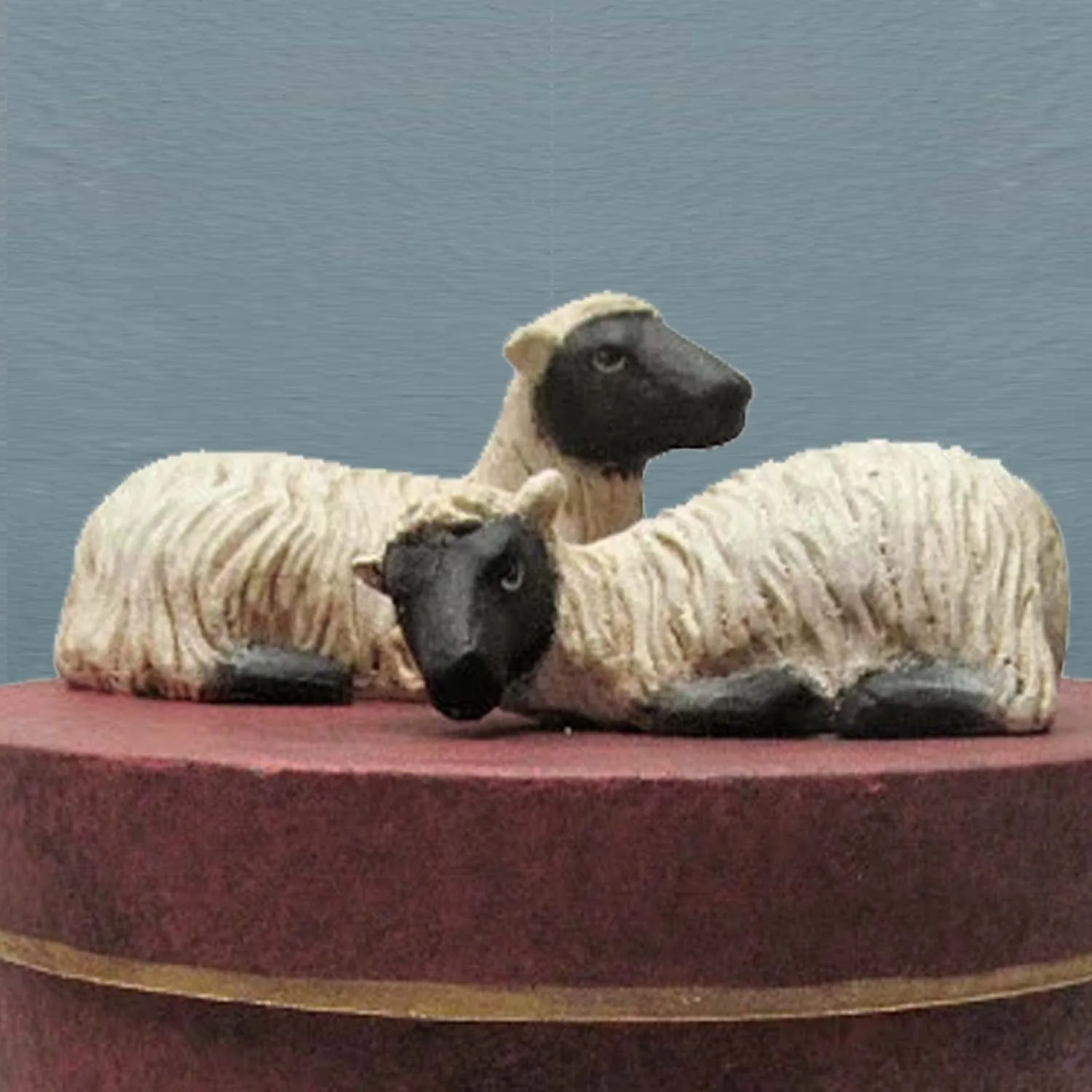 PAIR OF SHEEP ON ROUND BOX