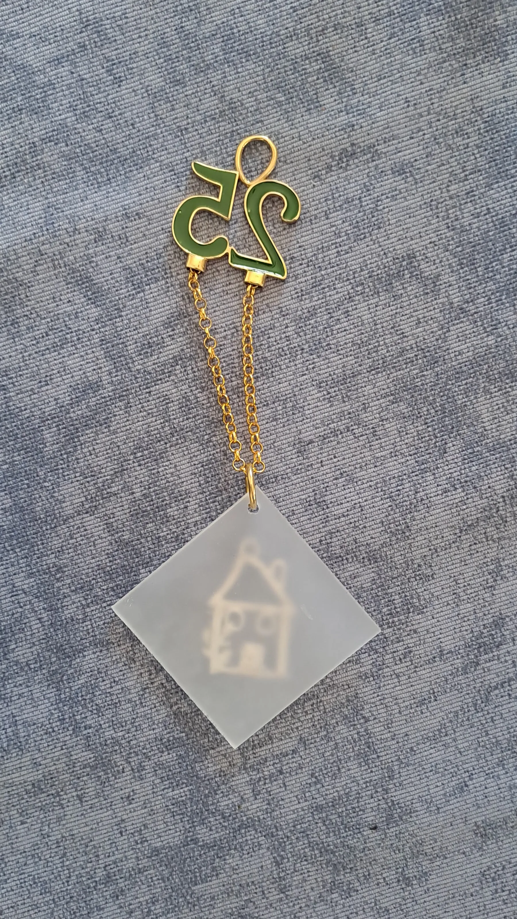 Sterling silver charm on plexiglass - House